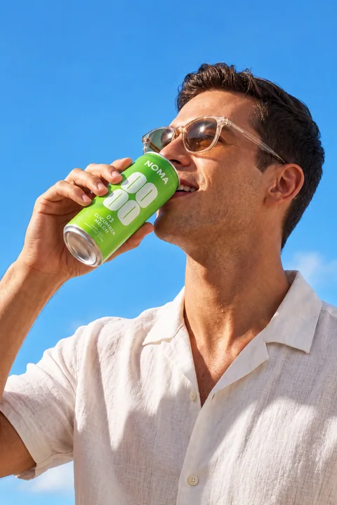 A man drinking NOMA in the sunshine